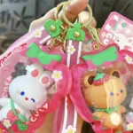 Customizable Yummy White Rabbit Strawberry Inflatable Pouch Keychain, cute strawberry-shaped storage bag charm with bear doll inside