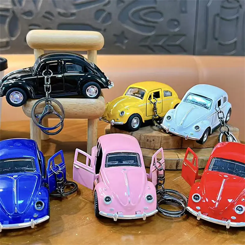 This Beetle Two-Door Toy Car Keychain is a classic vintage model car pendant highly restored from the iconic Beetle vehicle. The two side doors can be opened freely, bringing interactive playability as well as decorative value. We supply multiple vibrant color selections including black, yellow, red, white, blue and pink to meet diverse market preferences. Made with exquisite craftsmanship, the mini car model features delicate metallic luster and smooth texture. Equipped with durable keyring clip, you can hang it on backpacks, handbags and keys conveniently. It is a popular stress relief toy for students, perfect merchandise for claw machines, gift shops, carnival prizes and novelty retail gifts. H2: Factory Wholesale & Custom Service Multiple classic color variants in stock Eco-friendly sturdy plastic & alloy material Direct factory supply, support OEM & ODM custom printing Strict quality inspection for bulk claw machine orders Stable short lead time for large wholesale demands Fast support for all buyer inquiries H2: Core Product Features Highly restored classic Beetle two-door car model Openable side doors for interactive fun Rich color options: black, yellow, red, white, blue, pink Exquisite finish with metallic texture Dual function: collectible model toy & portable bag pendant Hot-selling item for claw machines, student gifts and retail merchandise
