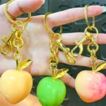 Peach Resin Keychain Pendant, glossy resin fruit bag charm with gold metal hardware