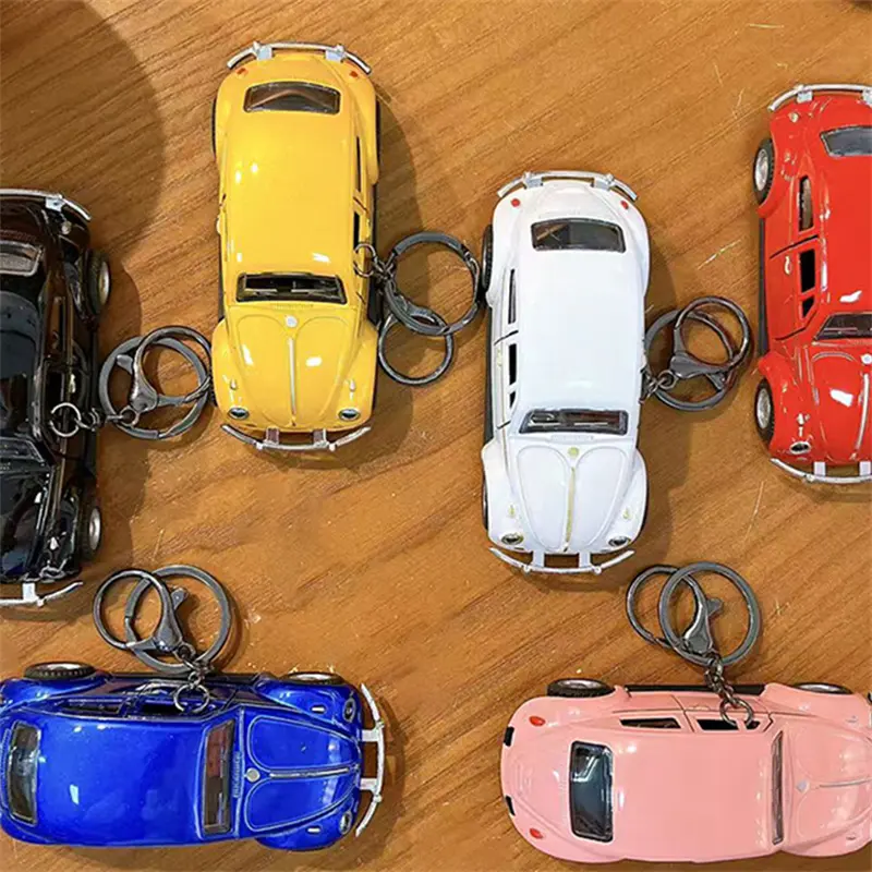 This Beetle Two-Door Toy Car Keychain is a classic vintage model car pendant highly restored from the iconic Beetle vehicle. The two side doors can be opened freely, bringing interactive playability as well as decorative value. We supply multiple vibrant color selections including black, yellow, red, white, blue and pink to meet diverse market preferences. Made with exquisite craftsmanship, the mini car model features delicate metallic luster and smooth texture. Equipped with durable keyring clip, you can hang it on backpacks, handbags and keys conveniently. It is a popular stress relief toy for students, perfect merchandise for claw machines, gift shops, carnival prizes and novelty retail gifts. H2: Factory Wholesale & Custom Service Multiple classic color variants in stock Eco-friendly sturdy plastic & alloy material Direct factory supply, support OEM & ODM custom printing Strict quality inspection for bulk claw machine orders Stable short lead time for large wholesale demands Fast support for all buyer inquiries H2: Core Product Features Highly restored classic Beetle two-door car model Openable side doors for interactive fun Rich color options: black, yellow, red, white, blue, pink Exquisite finish with metallic texture Dual function: collectible model toy & portable bag pendant Hot-selling item for claw machines, student gifts and retail merchandise