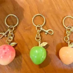 Peach Resin Keychain Pendant, glossy resin fruit bag charm with gold metal hardware