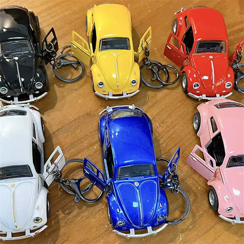 This Beetle Two-Door Toy Car Keychain is a classic vintage model car pendant highly restored from the iconic Beetle vehicle. The two side doors can be opened freely, bringing interactive playability as well as decorative value. We supply multiple vibrant color selections including black, yellow, red, white, blue and pink to meet diverse market preferences. Made with exquisite craftsmanship, the mini car model features delicate metallic luster and smooth texture. Equipped with durable keyring clip, you can hang it on backpacks, handbags and keys conveniently. It is a popular stress relief toy for students, perfect merchandise for claw machines, gift shops, carnival prizes and novelty retail gifts. H2: Factory Wholesale & Custom Service Multiple classic color variants in stock Eco-friendly sturdy plastic & alloy material Direct factory supply, support OEM & ODM custom printing Strict quality inspection for bulk claw machine orders Stable short lead time for large wholesale demands Fast support for all buyer inquiries H2: Core Product Features Highly restored classic Beetle two-door car model Openable side doors for interactive fun Rich color options: black, yellow, red, white, blue, pink Exquisite finish with metallic texture Dual function: collectible model toy & portable bag pendant Hot-selling item for claw machines, student gifts and retail merchandise