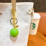 Peach Resin Keychain Pendant, glossy resin fruit bag charm with gold metal hardware