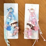 bear-hugging doll matching couple keychain, cute resin doll bag charm with braided lanyard