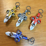 Red pull back sword fidget toy keychain with propeller design, ABS bag charm